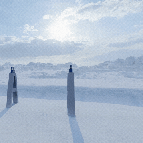 A snowy landscape with two poles in the foreground.